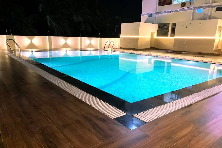 The hotel swimming pool lit at night