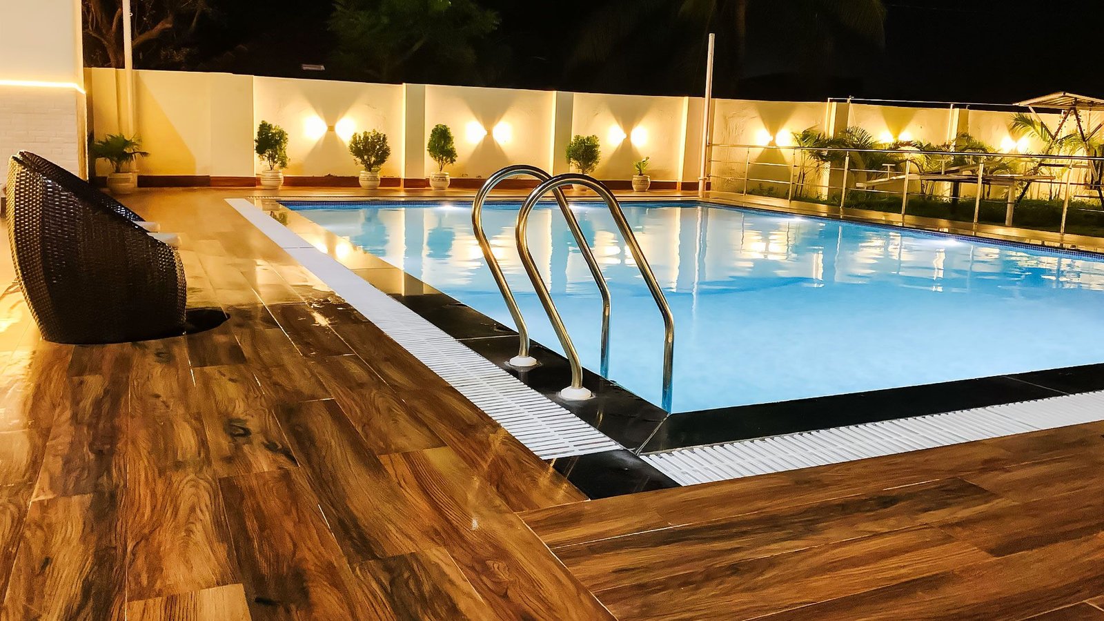 The hotel swimming pool lit at night